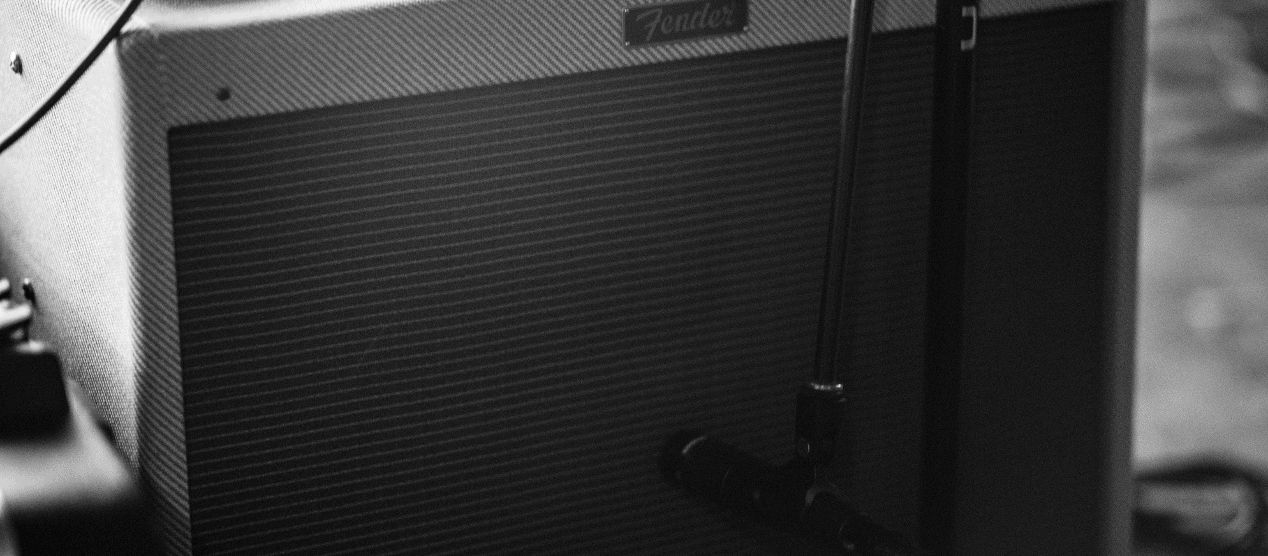 Try a mic on top of or behind the amp when recording